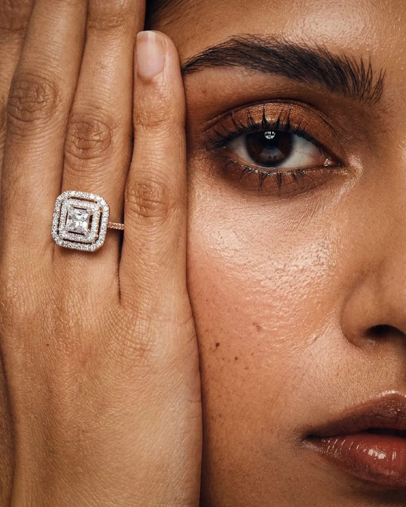 Carré Ring, No. 006, an emerald cut diamond in a double halo, worn on the hand