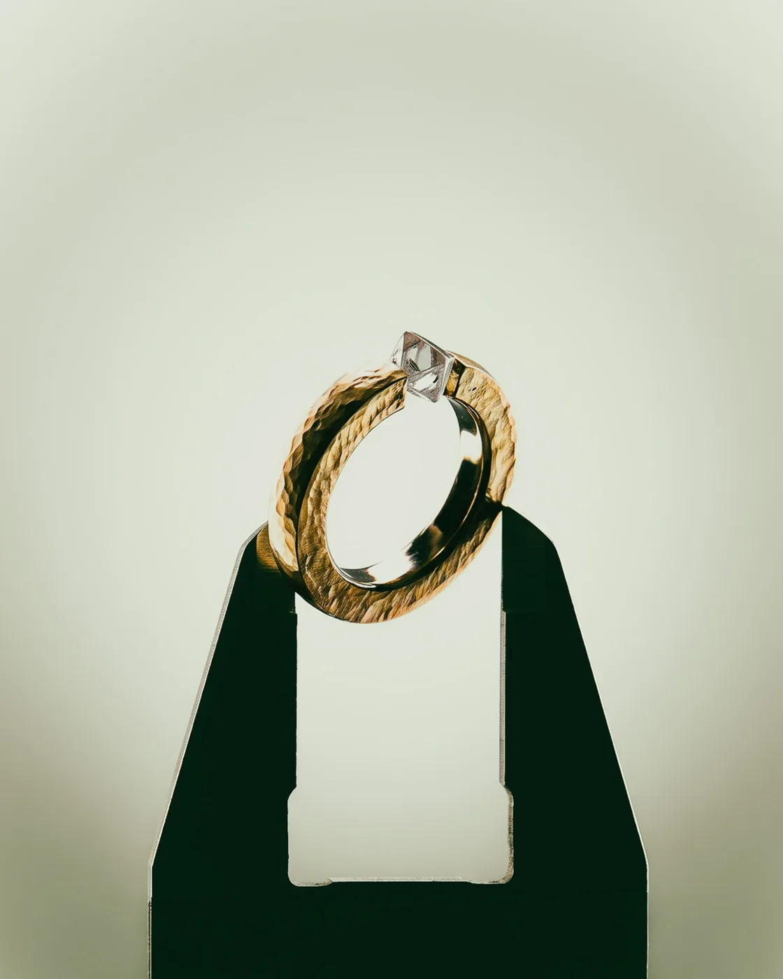 Rough Ring II, No. 010, the hammered gold band on a stand