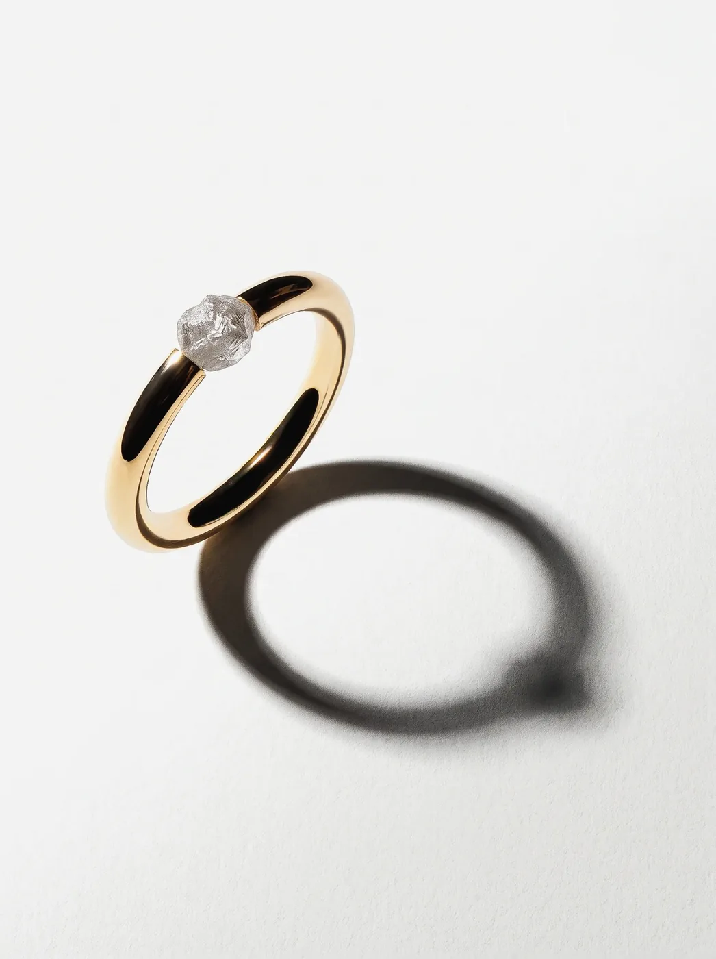 Rough Ring I, No. 009, the polished gold band standing, with its shadow